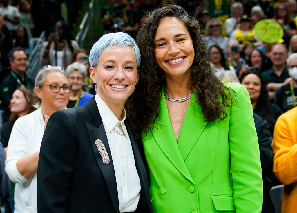 FILE - Megan Rapinoe, left, and Sue Bird pose for photographs before a WNBA basketball game between the Storm and the Washington Mystics, Sunday, June 11, 2023, in Seattle. (AP Photo/Lindsey Wasson, File)