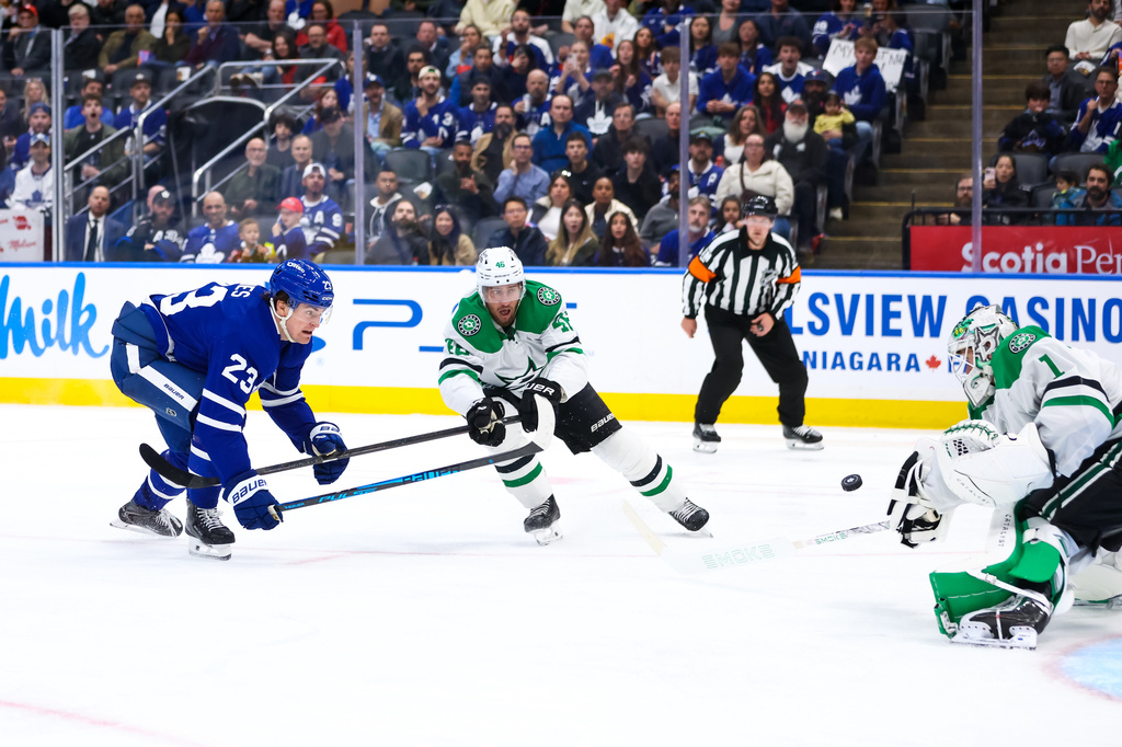 Toronto Maple Leafs left wing Matthew Knies (23) tries to shoot on net against Dallas Stars defenseman Ilya Lyubushkin (46) and goalie Casey DeSmith (1) during second-period NHL hockey game action in Toronto, Monday, April 13, 2026. (Cole Burston/The Canadian Press via AP)