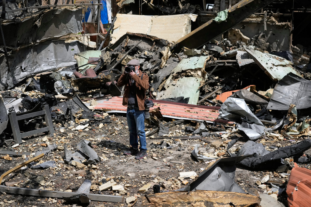 A photographer takes pictures of damage at Shahid Beheshti University after U.S.-Israeli airstrikes Friday in Tehran, Iran, Saturday, April 4, 2026. (AP Photo/Vahid Salemi)