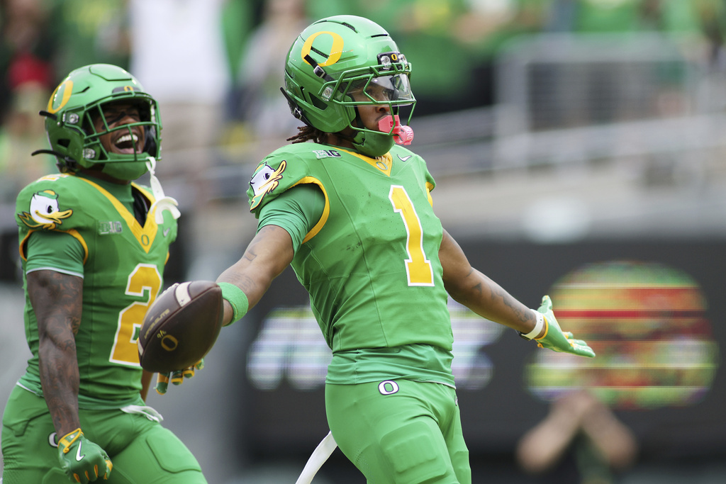 Oregon wide receiver Dakorien Moore (1) celebrates after a touchdown during the first half of an NCAA college football game against Oklahoma State, Saturday, Sept. 6, 2025, in Eugene, Ore. (AP Photo/Lydia Ely)