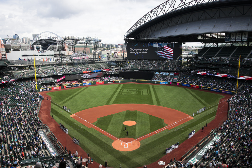 The No. 51 of former Seattle Mariners player Ichiro Suzuki is displayed in the outfield during the national anthem at a baseball game between the Chicago White Sox and the Mariners, Thursday, Aug. 7, 2025, in Seattle. (AP Photo/Jason Redmond)