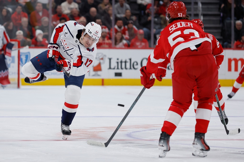 Washington Capitals center Dylan Strome (17) shoots the puck past Detroit Red Wings defenseman Moritz Seider (53) during the first period of an NHL hockey game Thursday, Jan. 29, 2026, in Detroit. (AP Photo/Duane Burleson)