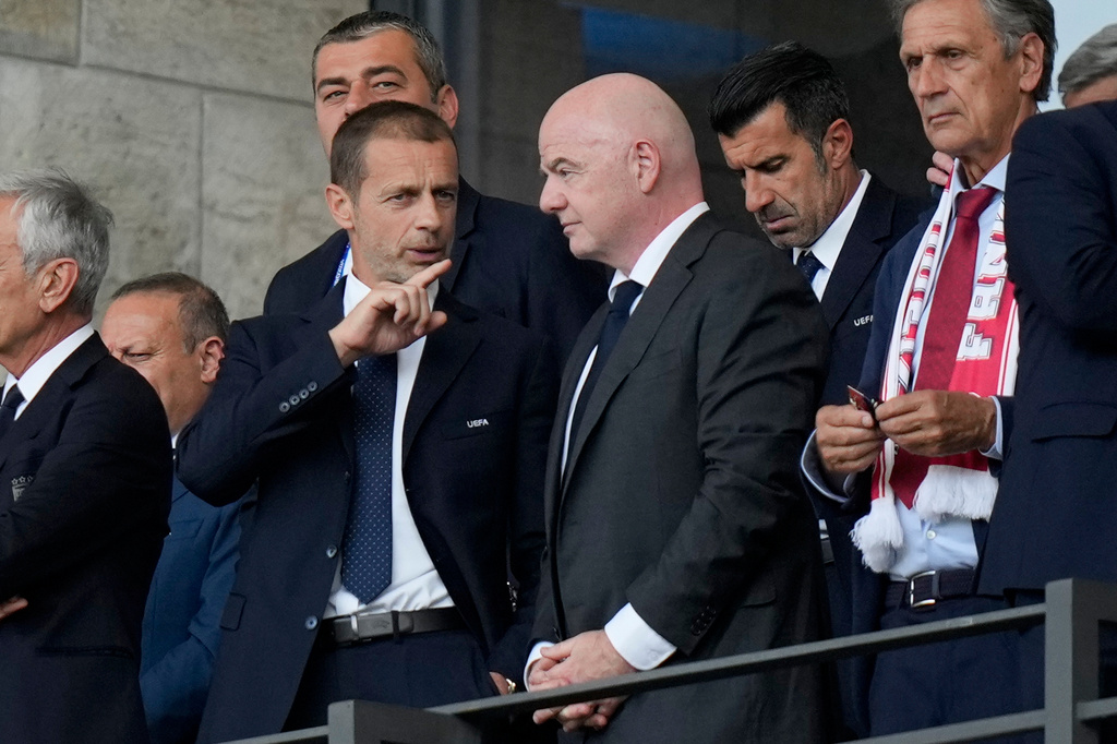 FILE - UEFA President Aleksander Ceferin, left, talks to FIFA President Gianni Infantino before a round of sixteen match between Switzerland and Italy at the Euro 2024 soccer tournament in Berlin, Germany, Saturday, June 29, 2024. (AP Photo/Matthias Schrader, File)