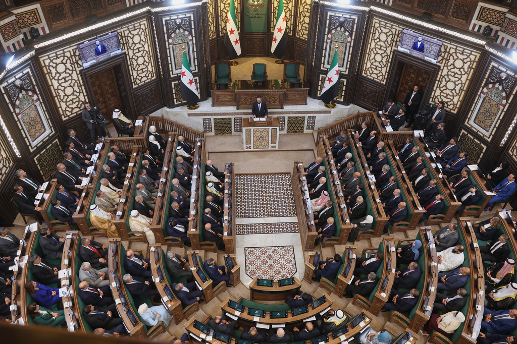 Syrian President Ahmad al-Sharaa addresses the inaugural session of Syria's newly formed People's Assembly, the first since the fall of President Bashar Assad's government, in Damascus, Syria, Sunday, July 12, 2026. (AP Photo/Ghaith Alsayed)