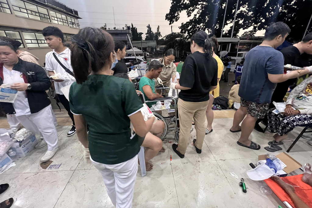 Patients wait outside the Cebu Provincial Hospital Bogo City after a strong earthquake struck in Bogo city, Cebu province, central Philippines on Wednesday, Oct. 1, 2025. (AP Photo)