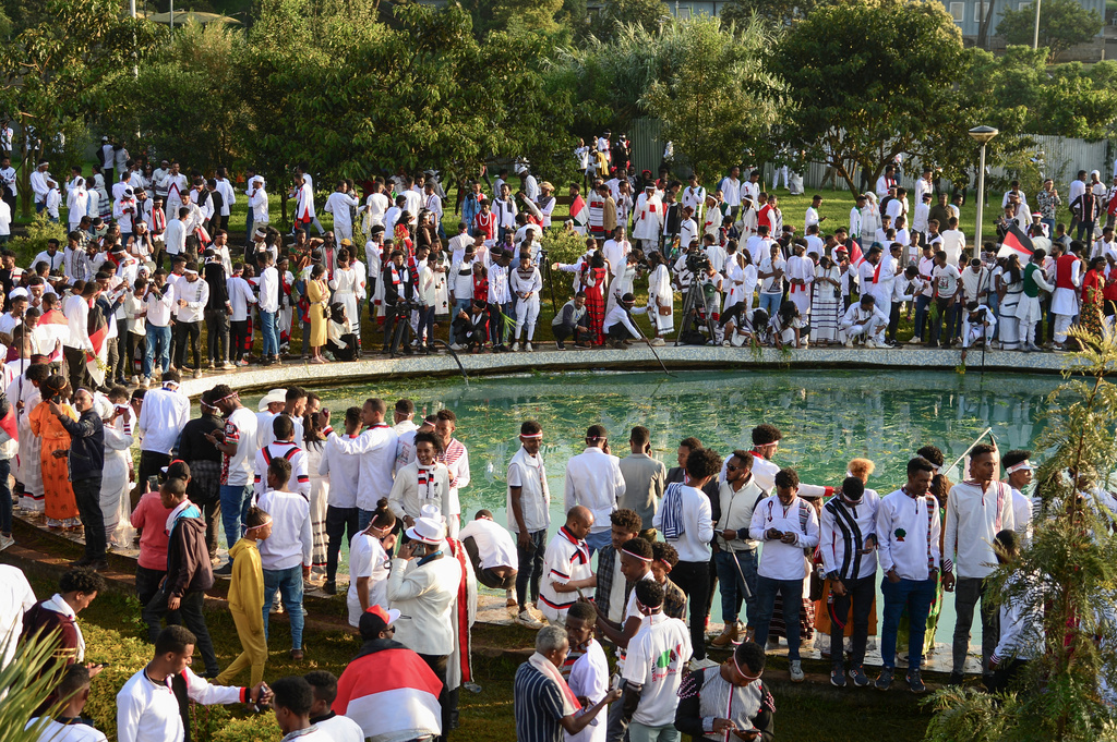 FILE - People throw grass and flowers into a pool of water as they celebrate the annual Irreecha festival in the capital Addis Ababa, Ethiopia, Oct. 1, 2022. (AP Photo/File)