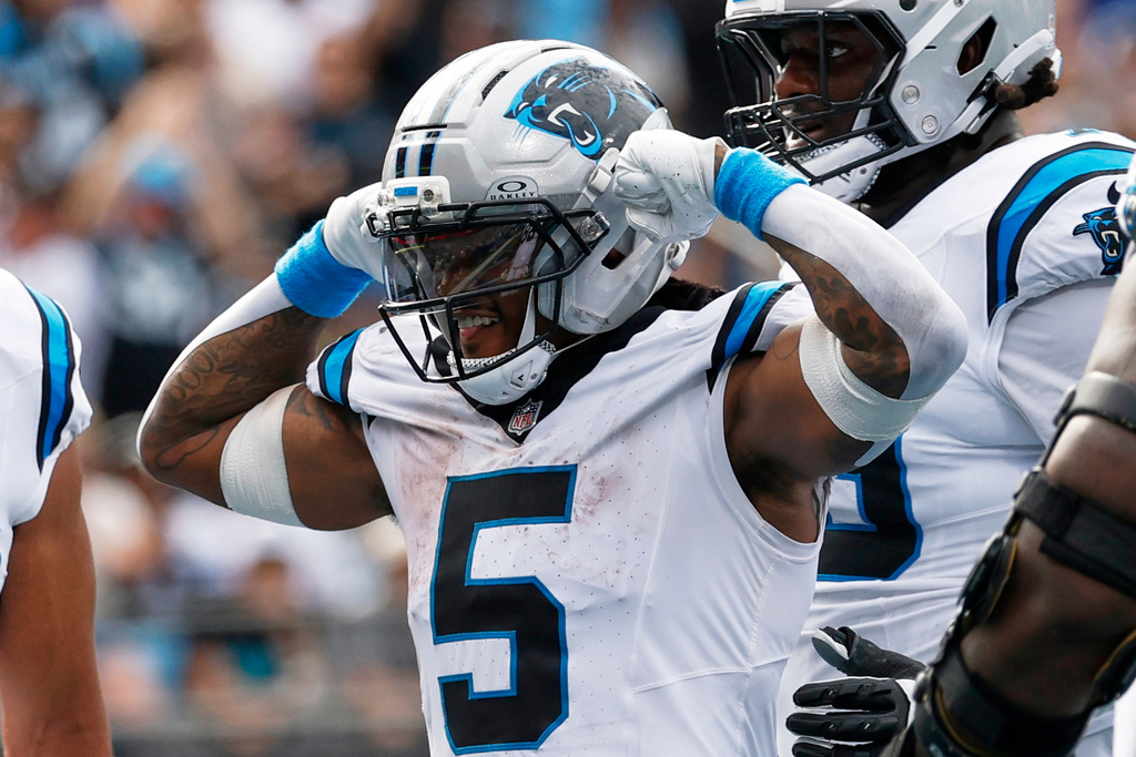 Carolina Panthers running back Rico Dowdle celebrates after scoring against the Miami Dolphins during the second half of an NFL football game, Sunday, Oct. 5, 2025, in Charlotte, N.C. (AP Photo/Jacob Kupferman)