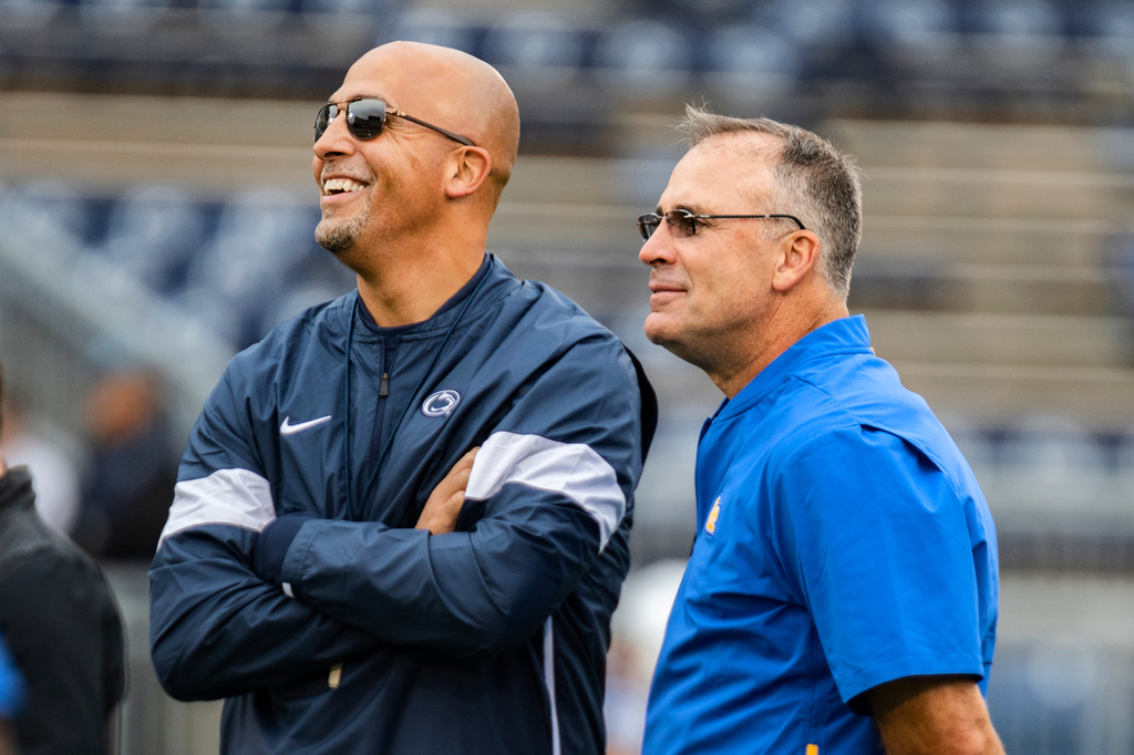 FILE - Penn State head coach James Franklin, left, talks with Pittsburgh head coach Pat Narduzzi before an NCAA college football game in State College, Pa., Saturday, Sept. 14, 2019. (AP Photo/Barry Reeger, File(