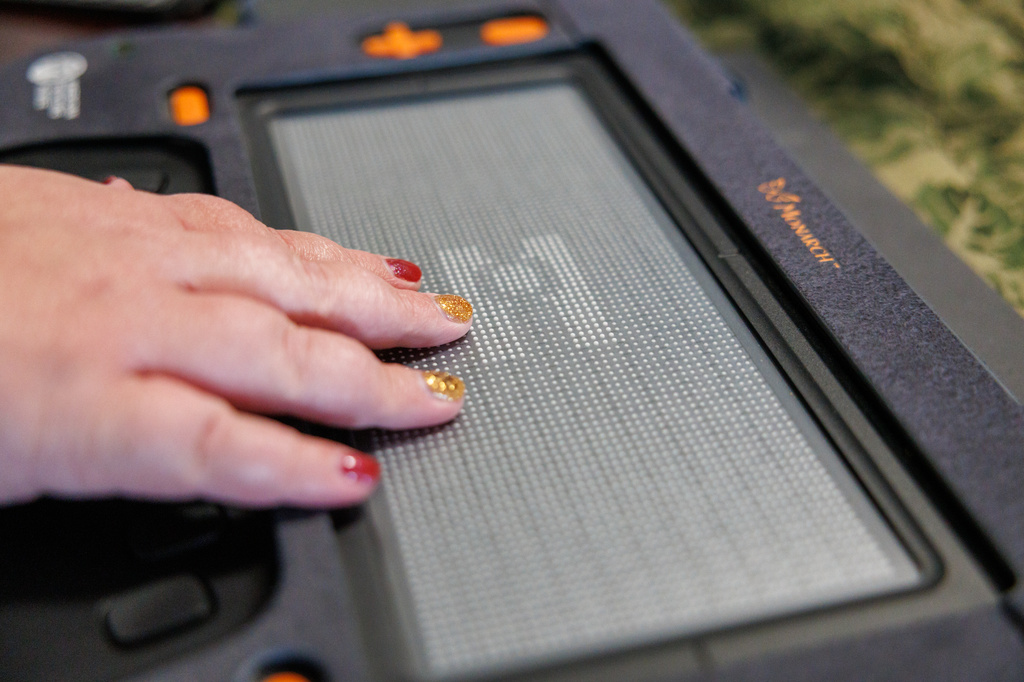 Rob Harris helps his daughter Isabelle Harris with her braille display on Thursday, June 18, 2026, in Grand Junction, Colo. (AP Photo/Jacob Spetzler)