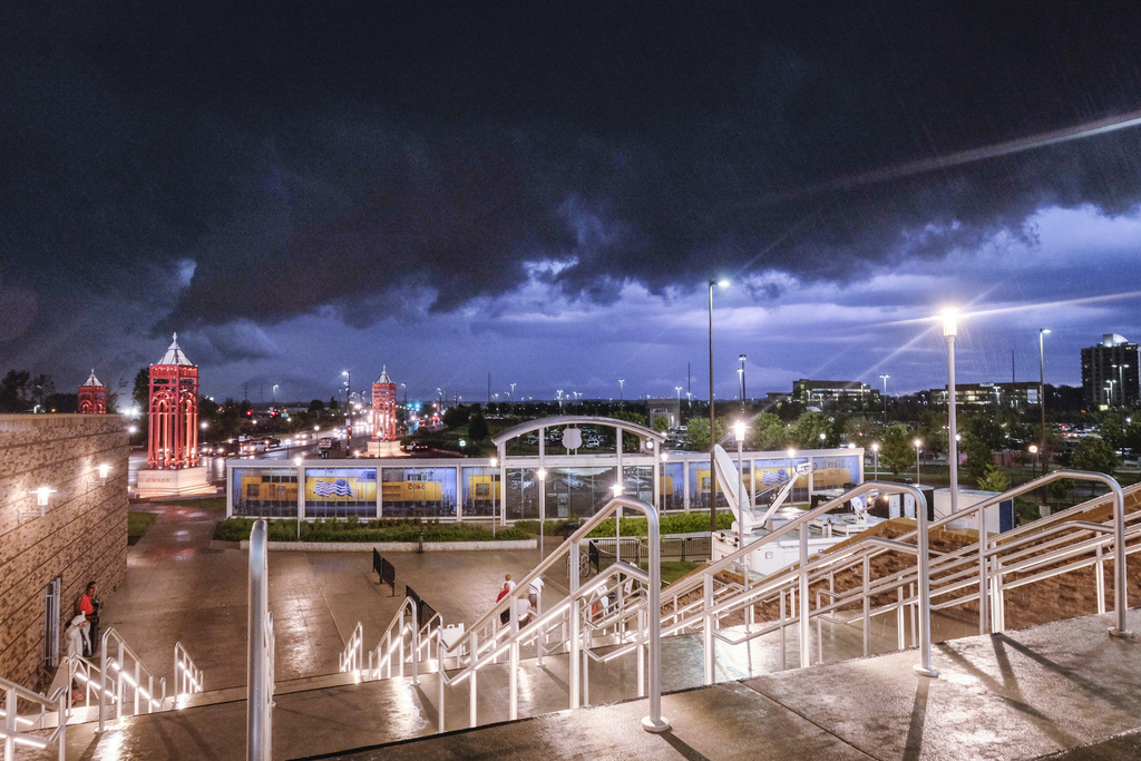 FILE - Dark storm clouds hang over TD Ameritrade Park and the Omaha skyline in Omaha, Neb., Friday, June 20, 2014, as the rain starts coming down. (AP Photo/Eric Francis, file)