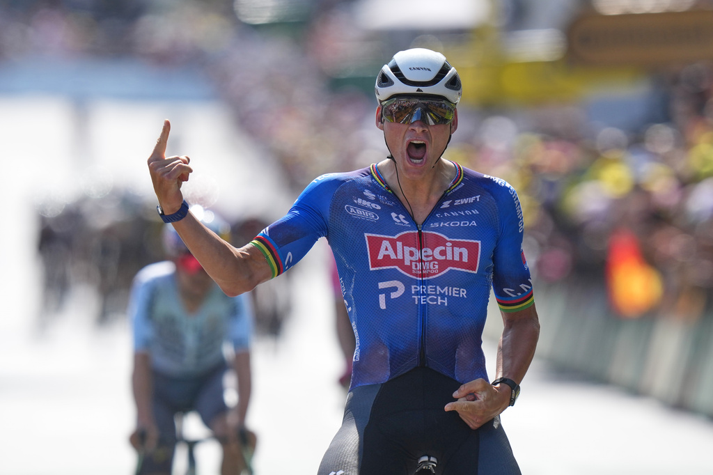 Netherland's Mathieu van der Poel celebrates as he crosses the finish line to win the ninth stage of the Tour de France cycling race with start in Malemort and finish in Ussel, France, Sunday, July 12, 2026. (AP Photo/Thibault Camus)