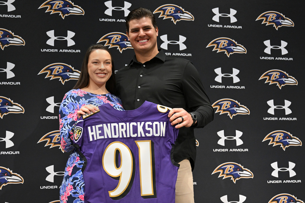 Baltimore Ravens defensive end Trey Hendrickson and his wife Alisa pose for a photo during an introductory NFL football press conference Friday, March 13, 2026, in Owings Mills, Md. (AP Photo/Gail Burton)