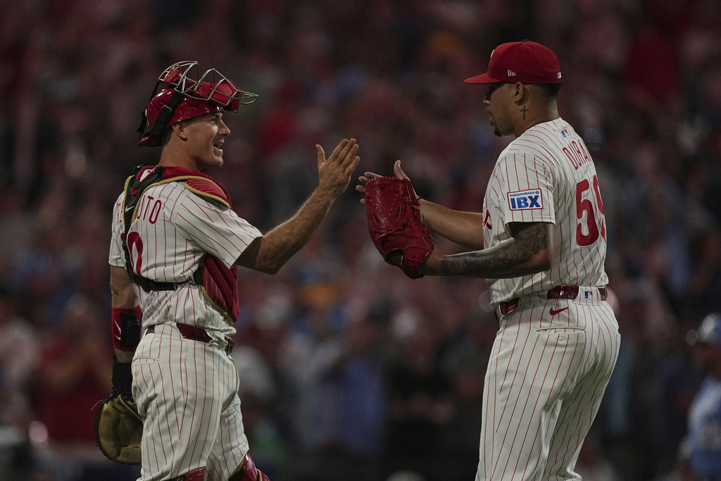 Philadelphia Phillies catcher J.T. Realmuto and pitcher Jhoan Duran, celebrate after the Phillies defeated the Kansas City Royals at a baseball game, Saturday, Sept. 13, 2025, in Philadelphia. (AP Photo/Matt Rourke)