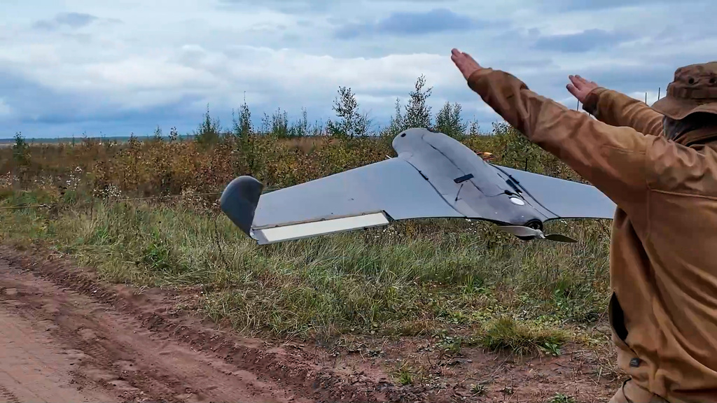 In this photo taken from video distributed by Russian Defense Ministry Press Service on Tuesday, Sept. 30, 2025, A Russian soldier launches a drone for an action in an undisclosed location in Ukraine. (Russian Defense Ministry Press Service via AP)