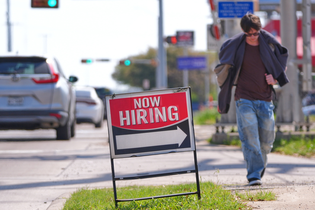 A now hiring sign sits on the side of the road in Garland, Texas, Monday, March 23, 2026. (AP Photo/LM Otero)