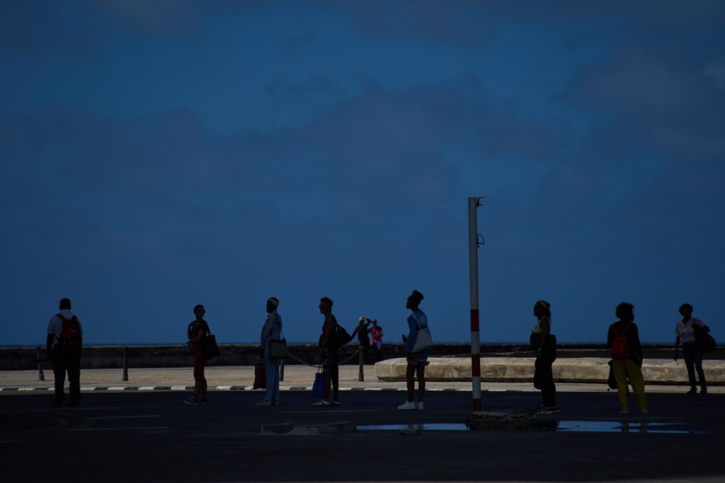 People wait to take public transportation during a blackout in Havana, Wednesday, March 4, 2026. (AP Photo/Ramon Espinosa)