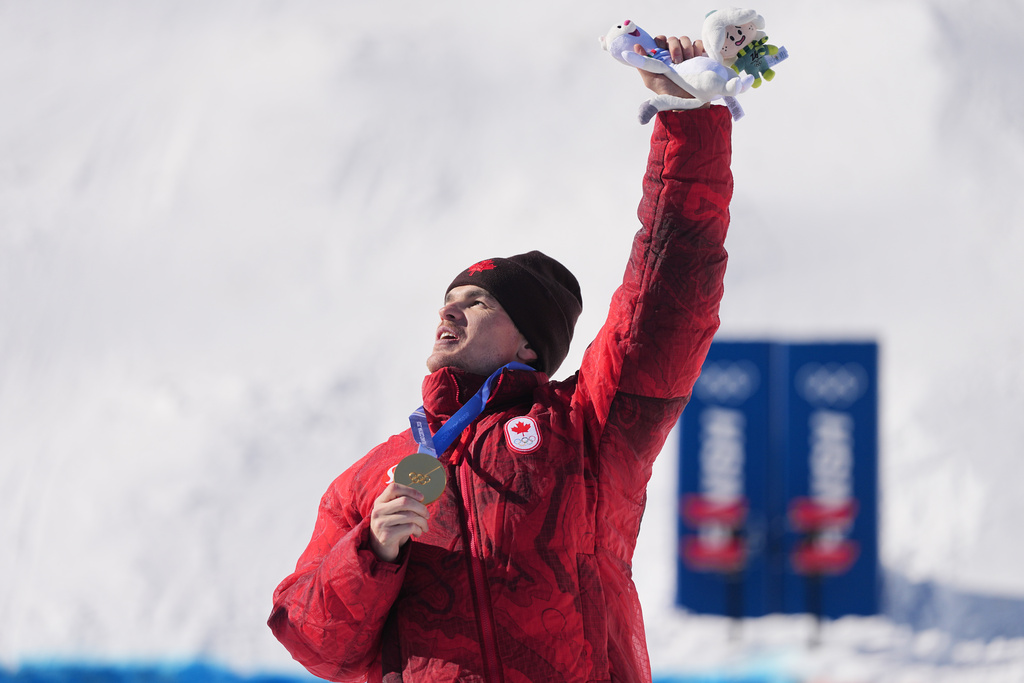 Gold medalist Canada's Mikael Kingsbury (4) celebrates after the men's freestyle skiing dual moguls finals at the 2026 Winter Olympics, in Livigno, Italy, Sunday, Feb. 15, 2026. (AP Photo/Gregory Bull)