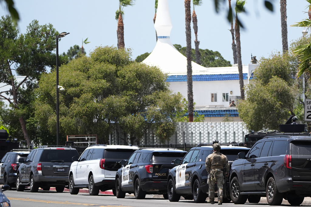 Police stage at the scene of a shooting outside the Islamic Center of San Diego Monday, May 18, 2026, in San Diego. (AP Photo/Gregory Bull)