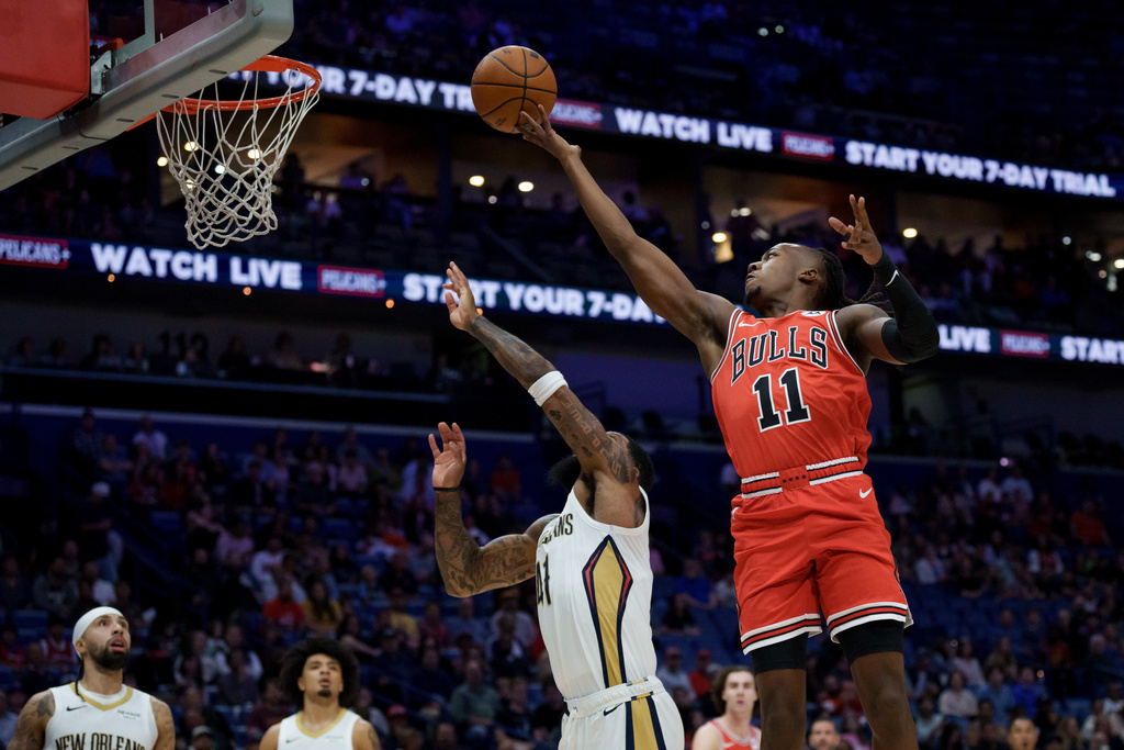 Chicago Bulls guard Ayo Dosunmu (11) shoots New Orleans Pelicans guard Saddiq Bey during the first half of an NBA basketball game in New Orleans, Monday, Nov. 24, 2025. (AP Photo/Matthew Hinton)