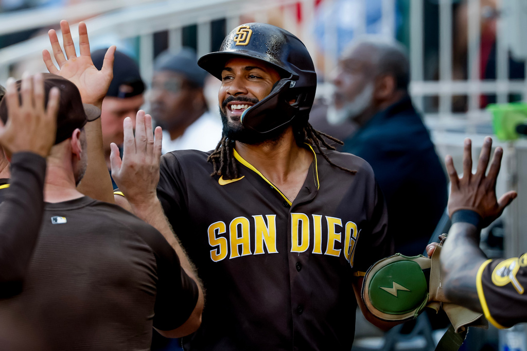 San Diego Padres' Fernando Tatis Jr. is greeted in the dugout after scoring against the Atlanta Braves during the first inning of a baseball game, Tuesday, July 21, 2026, in Atlanta. (AP Photo/Erik S. Lesser)
