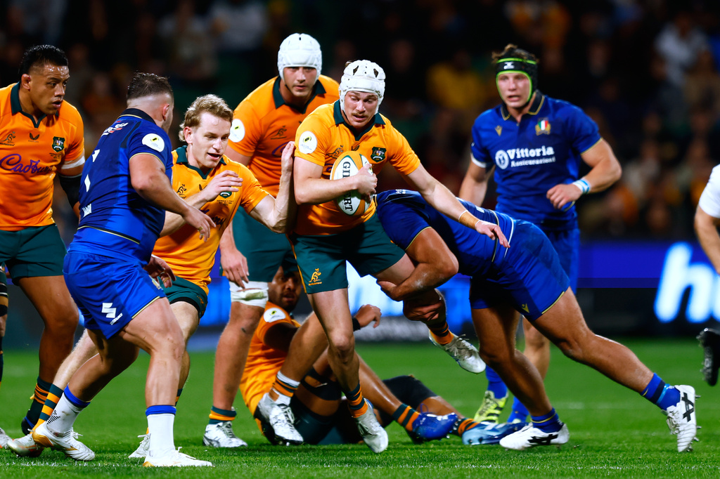 Australia's Declan Meredith, center, is tackled while making a run against Italy during their Nations Championship rugby international test match in Perth, Australia, Saturday, July 18, 2026. (AP Photo/Gary Day)