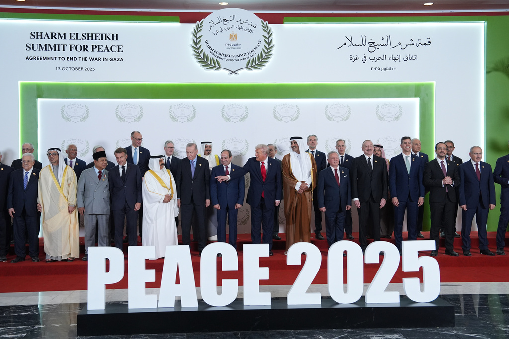 President Donald Trump and other leaders gather for a family photo during a summit to support ending the more than two-year Israel-Hamas war in Gaza after a breakthrough ceasefire deal, Monday, Oct. 13, 2025, in Sharm El Sheikh, Egypt. (AP Photo/Evan Vucci, Pool)