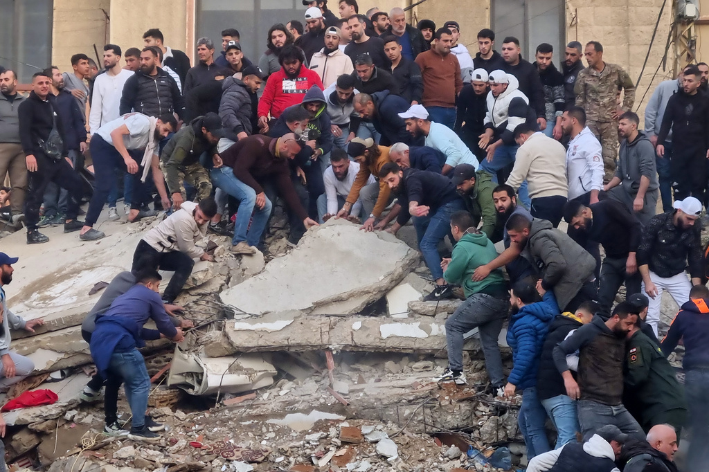 Rescue workers and residents search for survivors in the rubble of a building that collapsed in the northern city of Tripoli, Lebanon, Sunday, Feb. 8, 2026. (AP Photo)