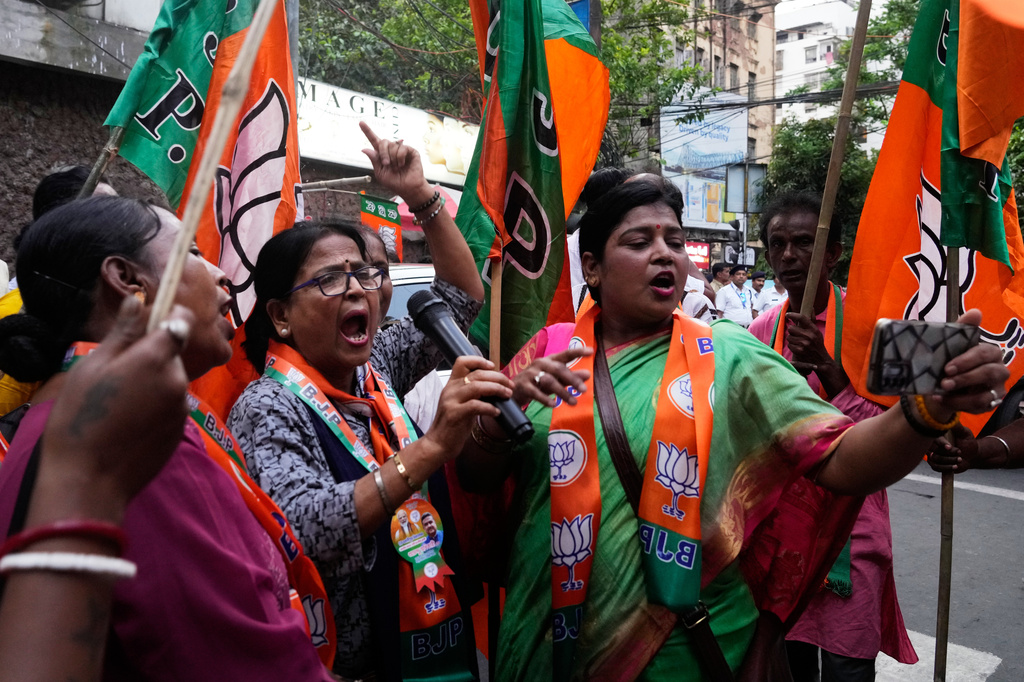 Supporters of Bharatiya Janata Party, BJP, shout slogans during a campaign rally for their candidate ahead of the West Bengal state Legislative Assembly elections, in Kolkata, India, Wednesday, April 22, 2026. (AP Photo/Bikas Das)