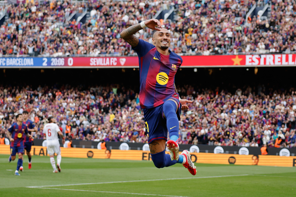 Barcelona's Raphinha celebrates after scoring during the Spanish La Liga soccer match between Barcelona and Sevilla in Barcelona, Spain, Sunday, March 15, 2026. (AP Photo/Joan Monfort)