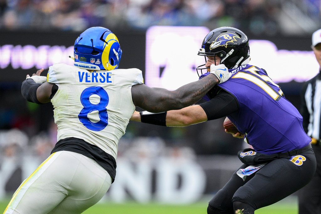 Los Angeles Rams linebacker Jared Verse (8) applies pressure on Baltimore Ravens quarterback Cooper Rush during the second half of an NFL football game Sunday, Oct. 12, 2025, in Baltimore. (AP Photo/Nick Wass)