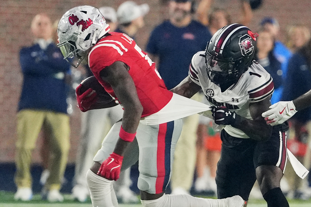 Mississippi running back Kewan Lacy (5) is shirt tackled by South Carolina defensive back DQ Smith (1) during the first half of an NCAA college football game Saturday Nov. 1, 2025, in Oxford, Miss. (AP Photo/Rogelio V. Solis)