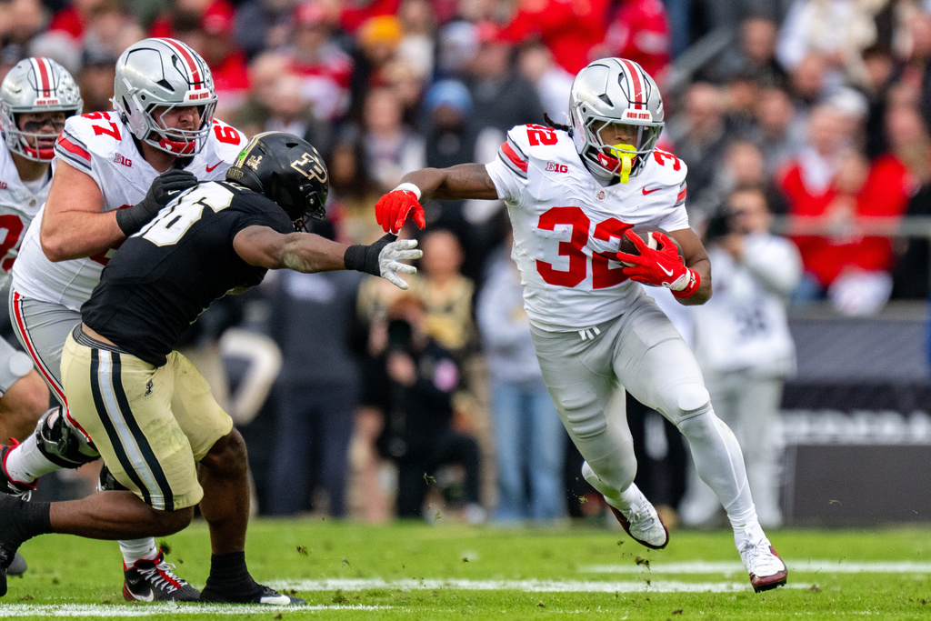 Ohio State running back Isaiah West (32) runs the ball out of the backfield during the first half of an NCAA college football game against Purdue, Saturday, Nov. 8, 2025, in West Lafayette, Ind. (AP Photo/Doug McSchooler)