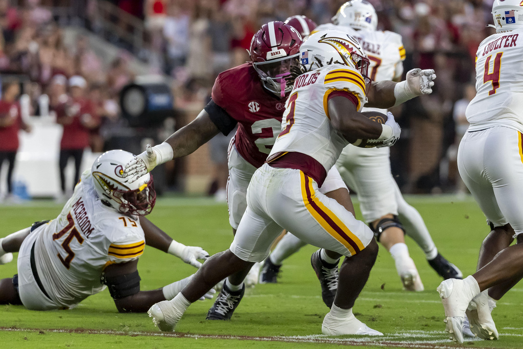 Alabama defensive lineman James Smith (23) tackles Louisiana-Monroe running back Braylon McReynolds (3) during the first half of an NCAA college football game, Saturday, Sept. 6, 2025, in Tuscaloosa, Ala. (AP Photo/Vasha Hunt)