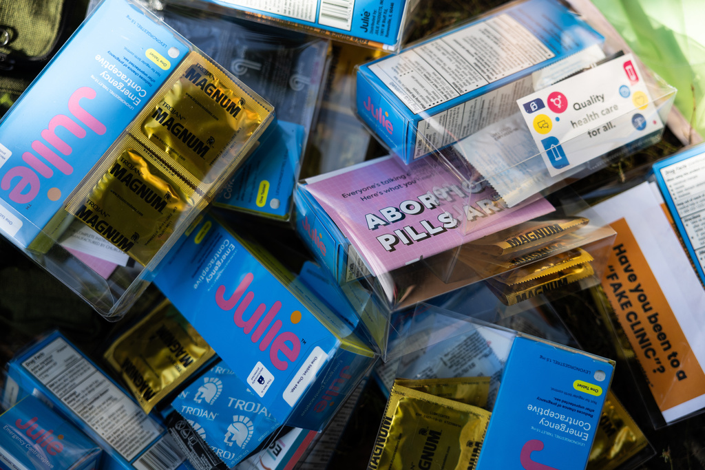Condoms, sexual health literature and emergency contraception are prepared for kits by DePaul University students at Oz Park in Chicago on Sunday, Sept. 28, 2025.(AP Photo/Heidi Zeiger)