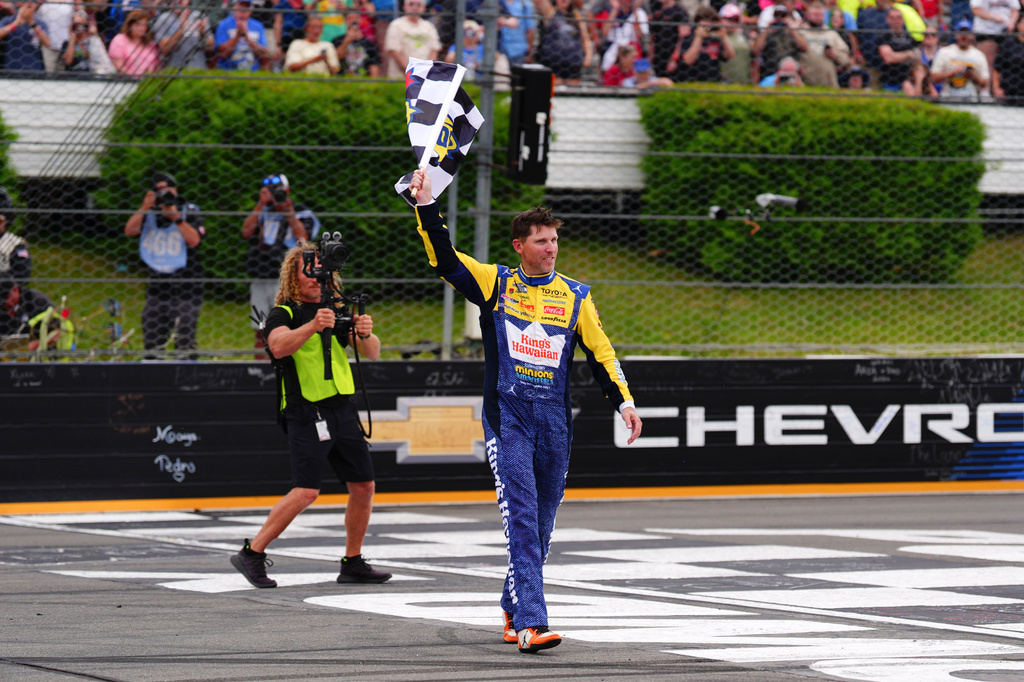 Denny Hamlin celebrates his win during a NASCAR Cup Series auto race at Pocono Raceway, Sunday, June 14, 2026, in Long Pond, Pa. (AP Photo/Derik Hamilton)