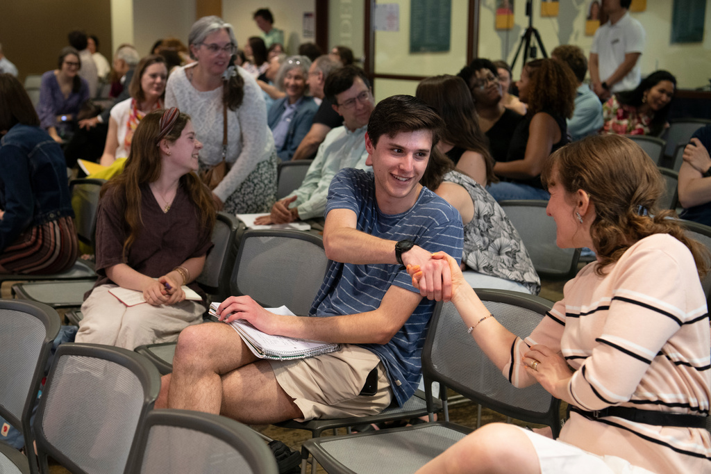 Itai Citrin shakes the hand of another attendee at a talk on climate uncertainty at American University in Washington on April 14, 2026. (AP Photo/Michael Phillis)