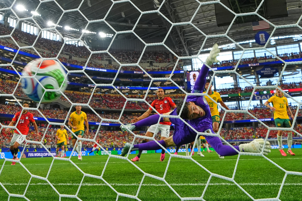 Egypt's Emam Ashour (8) scores the opening goal past Australia goalkeeper Patrick Beach (18) during the World Cup round of 32 soccer match between Australia and Egypt in Arlington, Texas, near Dallas, Friday, July 3, 2026. (AP Photo/Julio Cortez)