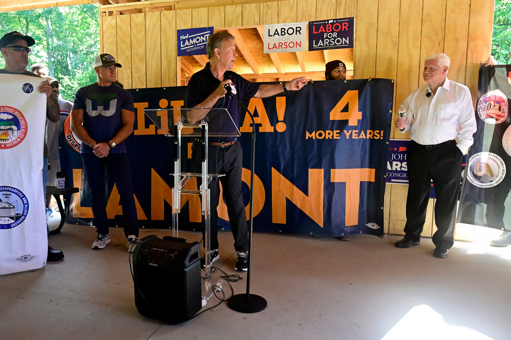 Connecticut Gov. Ned Lamont, center, gestures toward U.S. Rep. John Larson, D-Conn., during a campaign event, Saturday, July 25, 2026, in Bristol, Conn. (AP Photo/Jessica Hill)