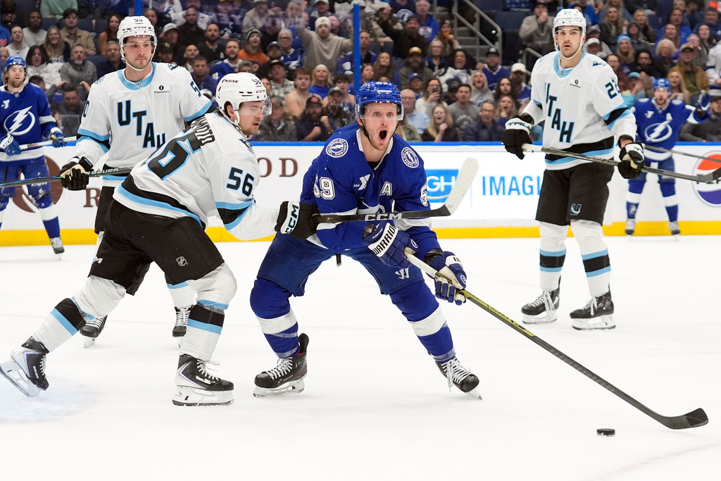 Tampa Bay Lightning center Jake Guentzel (59) looks for a pentalty call as he battles with Utah Mammoth right wing Kailer Yamamoto (56) during the second period of an NHL hockey game Monday, Jan. 26, 2026, in Tampa, Fla. (AP Photo/Chris O'Meara)