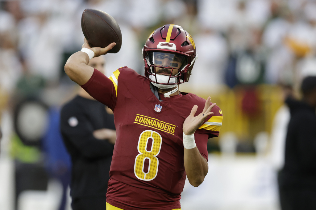FILE - Washington Commanders quarterback Marcus Mariota warms up before an NFL football game against the Green Bay Packers Sept. 11, 2025, in Green Bay, Wis. (AP Photo/Matt Ludtke, File)