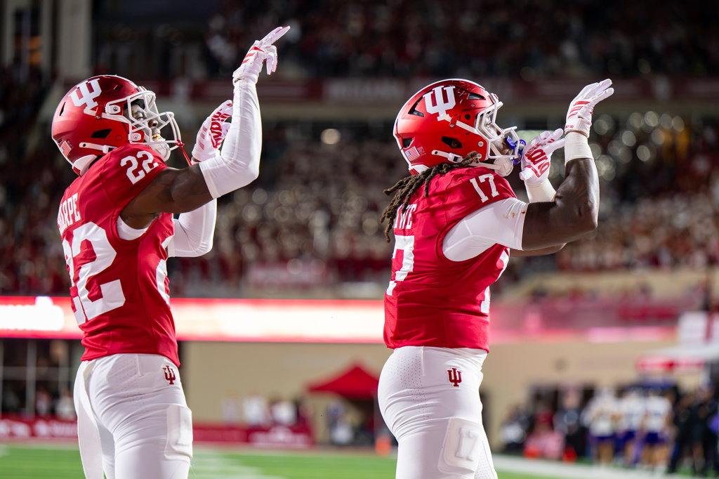 Indiana defensive back Jamari Sharpe (22) and defensive lineman Daniel Ndukwe (17) react after scoring a safety against Northwestern during the first half of an NCAA college football game, Friday, Sept. 25, 2026, in Bloomington, Ind. (AP Photo/Doug McSchooler)