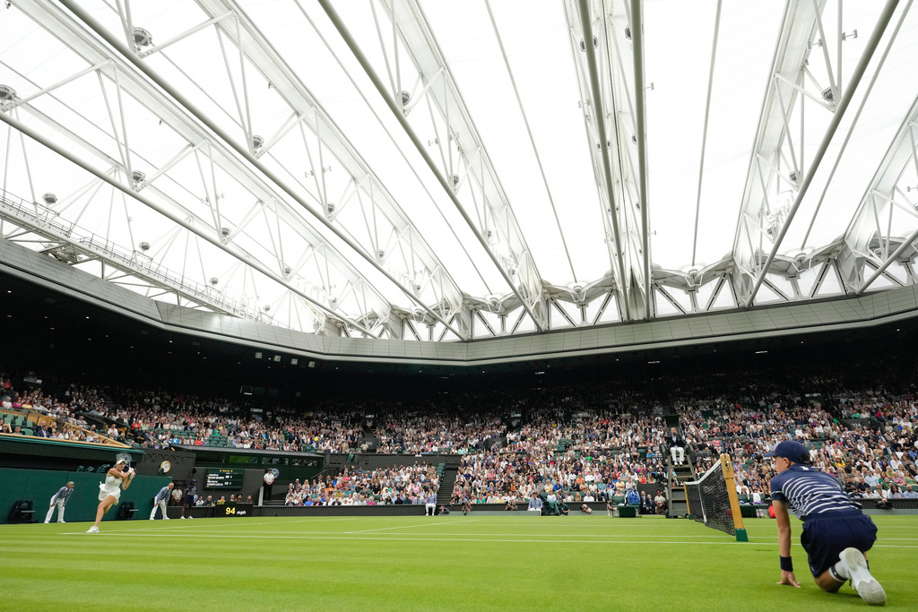 FILE -Marketa Vondrousova of the Czech Republic plays a backhand return to Jessica Bouzas Maneiro of Spain on Centre Court during their first round match at the Wimbledon tennis championships in London, July 2, 2024. (AP Photo/Kirsty Wigglesworth, File)