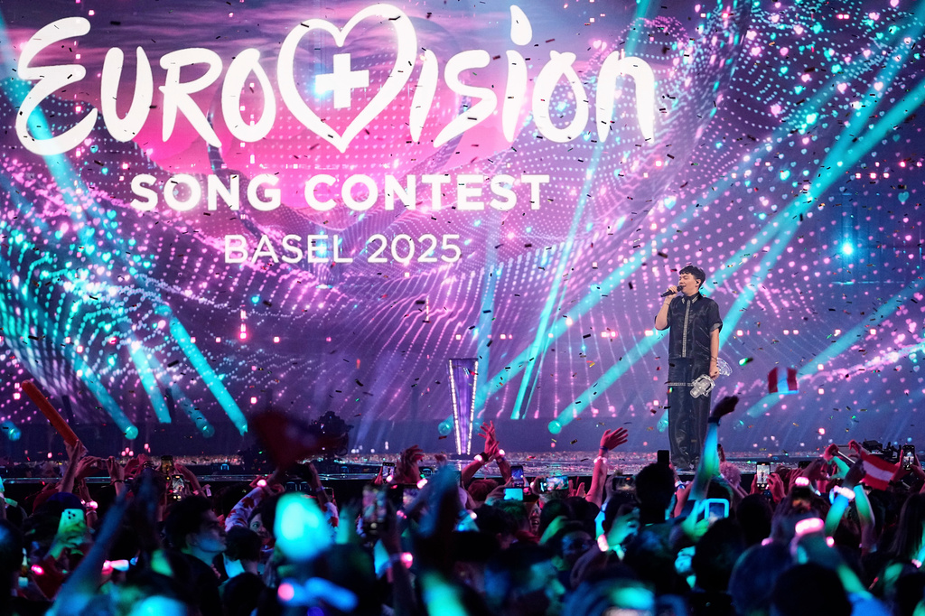 FILE - JJ from Austria stands on the stage with the trophy after winning the Grand Final of the 69th Eurovision Song Contest, in Basel, Switzerland, May 18, 2025. (AP Photo/Martin Meissner, File)