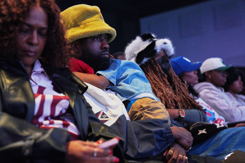 Christian podcaster and poet, Preston Perry, second from left, and his wife, Jackie Hill Perry, a Christian rapper and podcaster, third from left, attend service at 2819 Church on Sunday, Nov. 16, 2025, in Atlanta. (AP Photo/Jessie Wardarski)