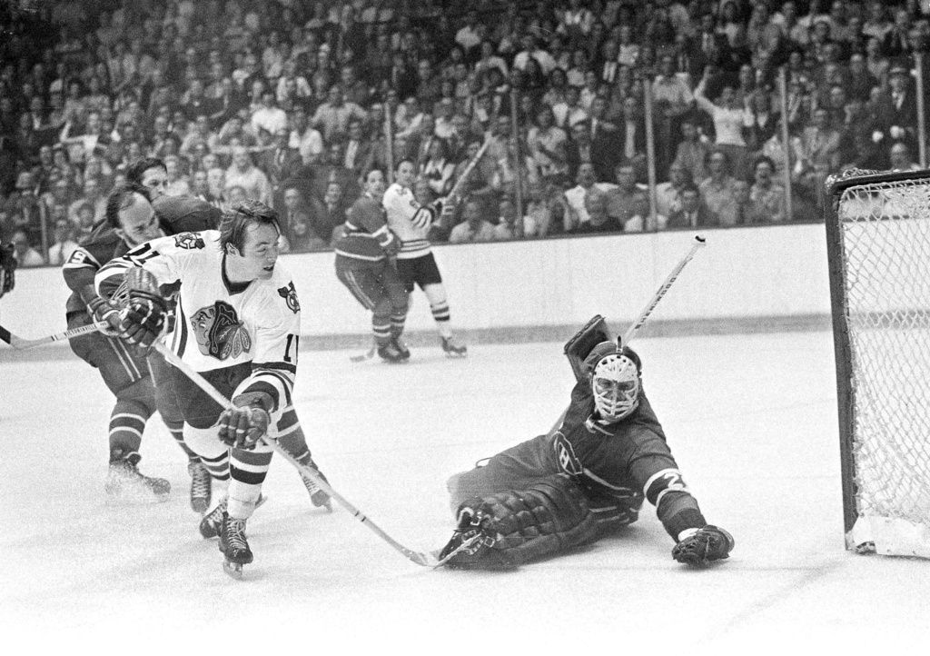 FILE - Montreal Canadiens goalie Ken Dryden makes a save off the stick of Boston Bruins Bob Schmautz, during their Stanley Cup hockey playoff game at Boston Garden, May 18, 1978. (AP Photo, File)