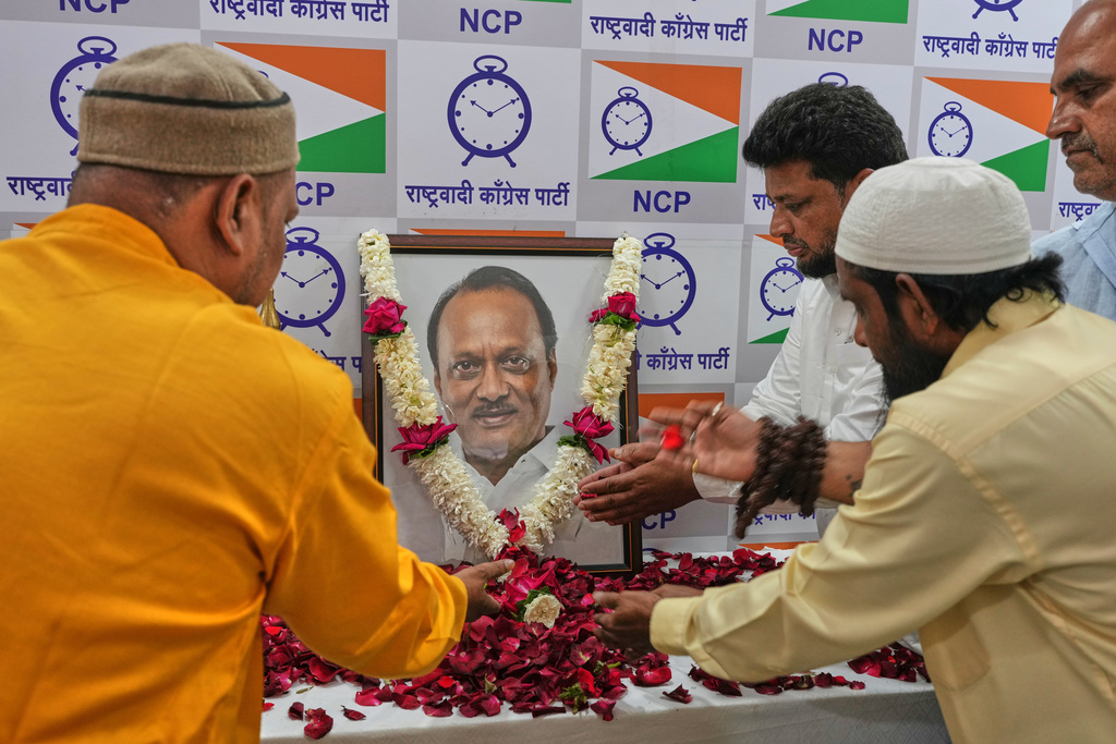 Supporters of Maharashtra Deputy Chief Minister Ajit Pawar pay homage near his photograph at the Nationalist Congress Party office in Mumbai, India after he was killed when a private plane carrying him crashed in western India on Wednesday, Jan. 28, 2026. (AP Photo/Rafiq Maqbool)