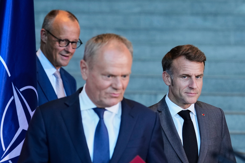 Poland's Prime Minister Donald Tusk, center, French President Emmanuel Macron, right, and German Chancellor Friedrich Merz attend a press conference at the E5 NATO Summit in Berlin, Germany, Wednesday, June 24, 2026. (AP Photo/Ebrahim Noroozi)