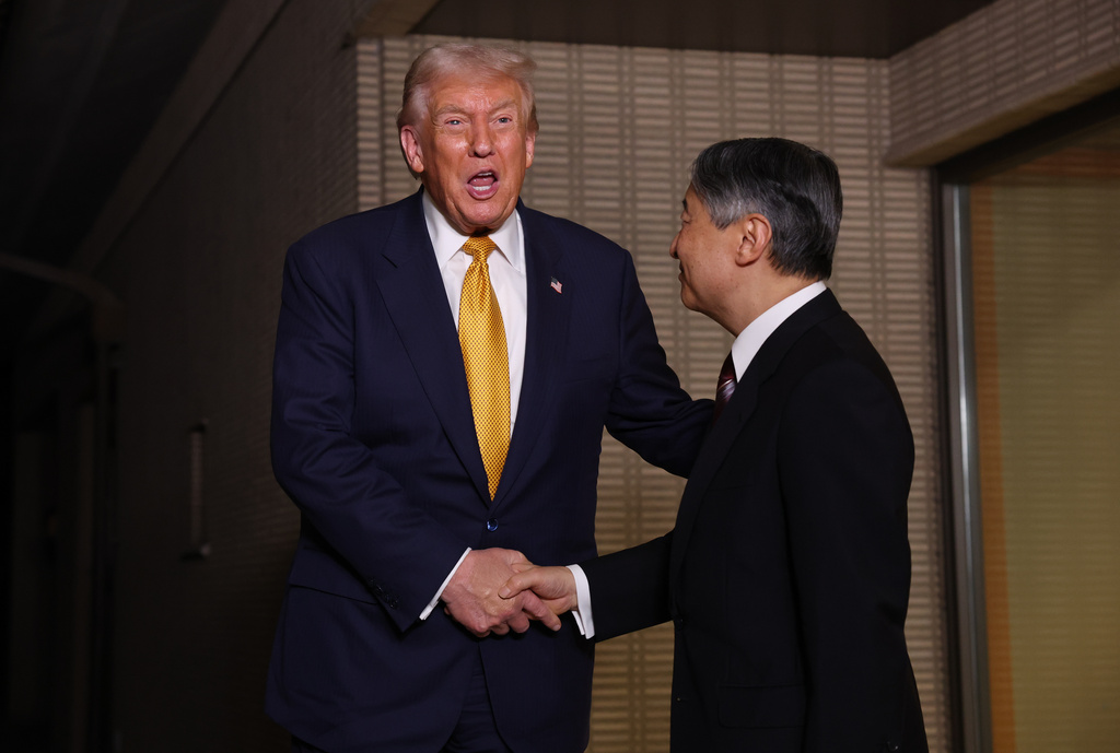 President Donald Trump, left, and Japan's Emperor Naruhito shake hands during their meeting at the Imperial Palace in Tokyo, Oct. 27, 2025. (Issei Kato/Pool Photo via AP)