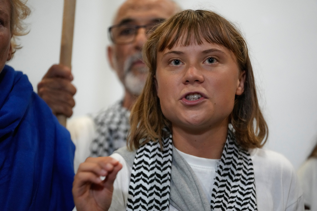 Swedish activist Greta Thunberg speaks as she arrives at the Eleftherios Venizelos International Airport in Athens, Monday, Oct. 6, 2025 after being deported from Israel for taking part in a Gaza-bound aid flottila. (AP Photo/Petros Giannakouris)