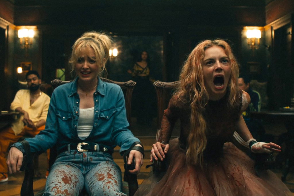 This image released by Searchlight Pictures shows Kathryn Newton, left, and Samara Weaving in a scene from "Ready or Not 2: Here I Come." (Pief Weyman/Searchlight Pictures via AP)